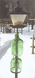 Two inverted bottles were enough modification to make this a squirrel-proof bird feeder pole.